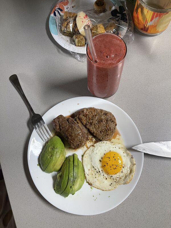 High protein breakfast - steak with eggs, avocado, and a smoothie on the side